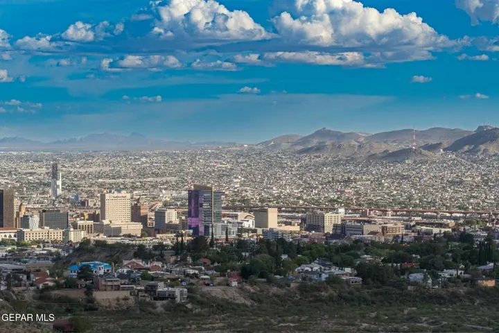 El Paso city skyline with Franklin Mountains and suburban homes in the foreground at golden hour
